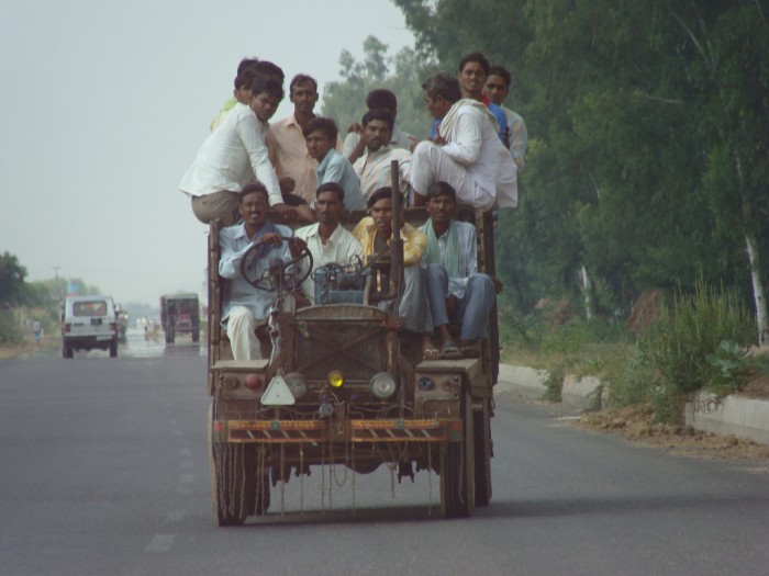 A vehicle in India is filled to the brim with carpoolers. (Photo by clara and james via Flickr)