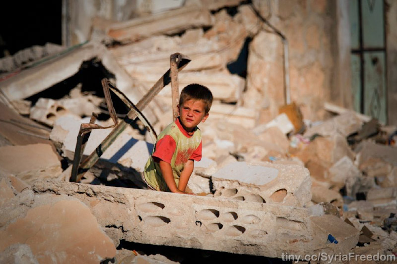A child surveys the damage to his family's house in Idlib, Syria after it was bombed by Assad warpalnes (Photo from Freedom House via Flickr)