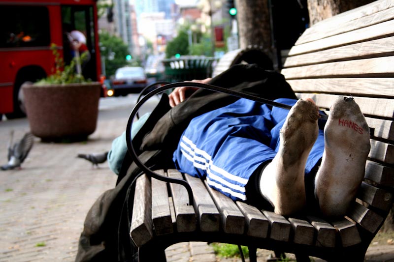 A homeless man sleeps in Pioneer Square. A count last January tallied 2736 people sleeping outside in King County without shelter. (Photo by C4Chaos via Flickr)