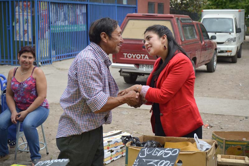 Karol Cariola, one of Chile's former student leaders and newly-elected members of Congress, meets with a constituent after the elections. (Photo by Eilís O'Neill)