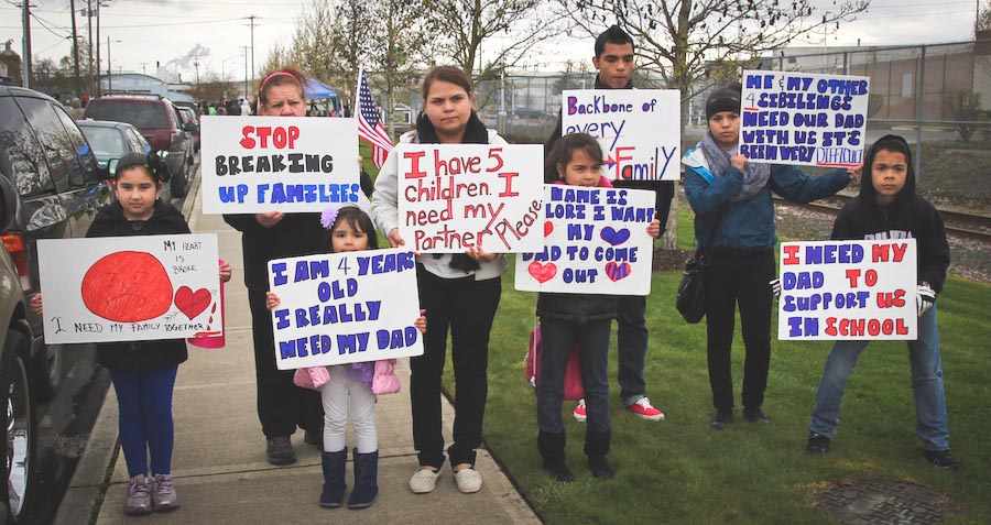 The family of detainee hold signs outside Northwest Detention Center during a demonstration on Saturday. (Photo by Lael Henterly)