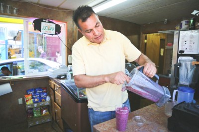 Sanjay Bhadu, owner of Jucivana Smoothies and Coffee on Yesler Ave says even with just one employee, minimum wage hikes will threaten his business. (Photo by Senhao Liu)