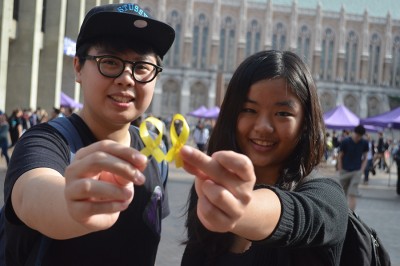 UW students Sophia Lo (Left) and Tina Choi (Right) hold yellow ribbons to show support for the Hong Kong protest. (Photo by Katy Wong)