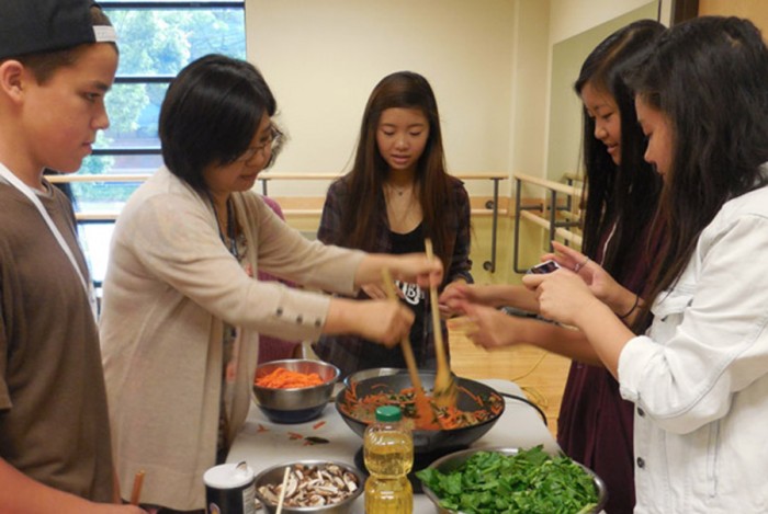 YouthCAN participants cook Korean food for elders at the International Community Health Services during the Summer 2014 culinary arts session. (Photo by Minh Nguyen)