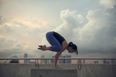 A woman practices the crow pose
