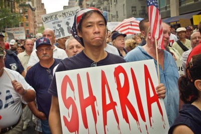A protester opposing the Park51 project, aka the "Ground Zero Mosque" carries an anti-sharia sign. According to CAIR-WA, National coverage of the controversy in 2010 coincided with an uptick in hate crimes targeting Muslims. (Photo by David Shankbone)