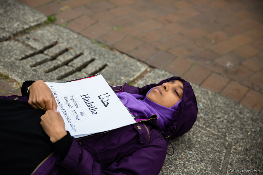 Fethya Ibrahim, a junior at UW, participates in a die-in on Red Square representing the depopulated Palestinian village Hadatha. Ibrahim was among fifty-some individuals who protested an Israeli celebration of the 1948 Palestinian exodus. (Photo by Aditya Ganapathiraju)
