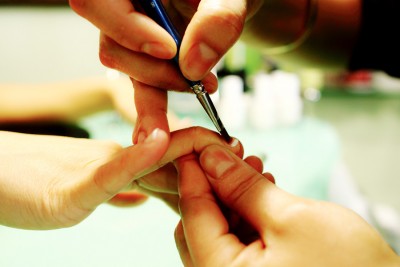 Getting your nails done is physically intimate, but often involves almost no verbal interaction with the manicurist due to language barriers. (Photo from Flickr by Angie Chung)