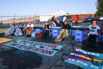 Citizens gathered outside the Northwest Detention Center in Tacoma in the dawn hours to blockade busses with deportees from leaving. (Photo by Angelica Chazaro)