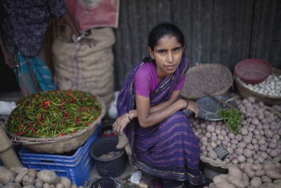 Khairun Nahar sells vegetables in the slum’s market. Photo: Chantal Anderson