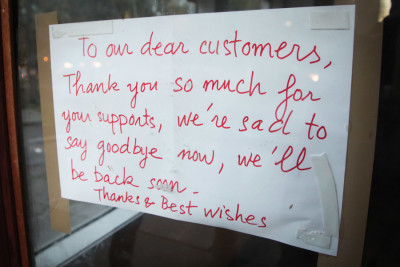 A sign was posted on the door of Yasuko's Teriyaki on the south end of Broadway in October informing customers the shop had closed indefinitely. (Photo by Alex Stonehill)