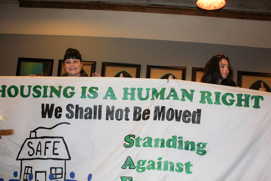 Pina Belgrano and daughter on Sunday, preparing for the “Turning the Tables” action to fight foreclosure of her Beacon Hill home. (Photo by Goorish Wibneh)