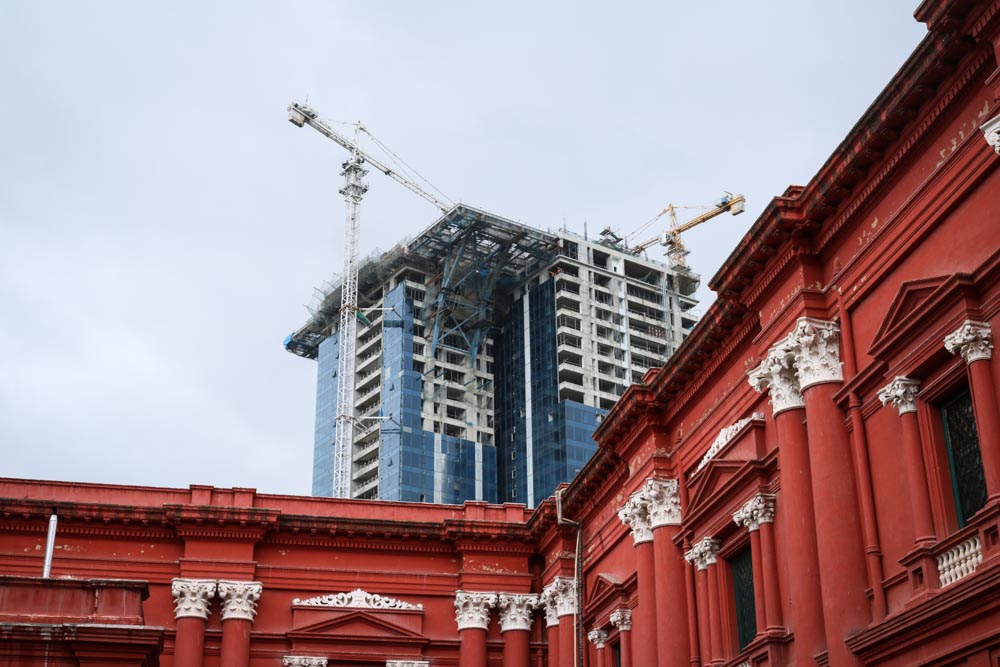 Old and new: Construction rises behind the second oldest museum in South India. Multi-story buildings, once absent in Bangalore, are springing up throughout the city. (Photo by Kate Clark)