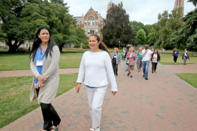 Native Education Certificate Program Co-Directors Elizabeth West, left, and Megan Bang, right, lead a group of their students across the Quad at University of Washington, which used to be a Duwamish Village. (Photo by Greg Gilbert / The Seattle Times)