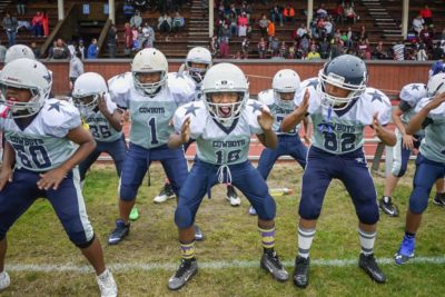 Beacon Hill Cowboy Junior Jarel Craig (center) and his teammates warm up before their game against the Renton Rangers. (Photo by Susan Fried)