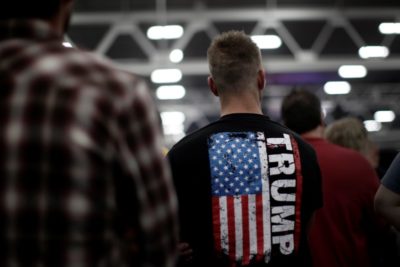 A man stands in the audience before Republican presidential nominee Donald Trump appears at a campaign rally in Manheim, Pennsylvania on October 1st. (Photo from Reuters / Mike Segar)