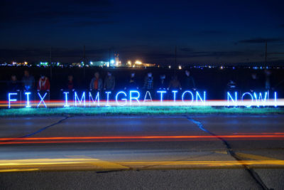 A highway-side protest calling for immigration reform in Kenosha County, Wisconsin. (Photo from Flickr by Joe Brusky)