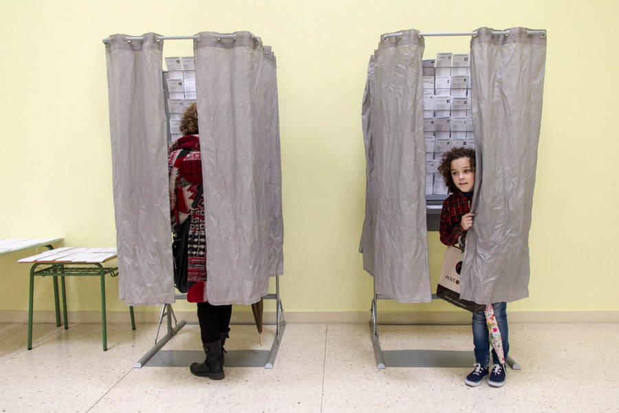 A girl goes with her mother to vote for the European Parliament elections in 2014. Most young Europeans we asked said they're watching the U.S. election closely and say it will impact their lives. (Photo from Flickr by Enrique Balenzategui Arbizu)